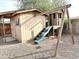 Backyard playground with a wooden shed, playhouse and swing set offers outdoor fun at 1109 E Emerald Ave, Mesa, AZ 85204