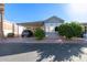 Charming home exterior with a covered carport, lush landscaping, and mature trees at 111 S Greenfield Rd # 97, Mesa, AZ 85206