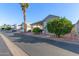 Single-story home with covered parking, complemented by lush, mature landscaping at 111 S Greenfield Rd # 97, Mesa, AZ 85206