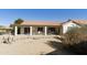 View of the backyard showcasing the covered patio and well-maintained landscaping with desert plants at 11115 E Bellflower Ct, Sun Lakes, AZ 85248