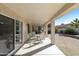 Wide covered patio featuring a dining area and sliding glass doors to the interior at 11115 E Bellflower Ct, Sun Lakes, AZ 85248