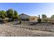 Beautiful backyard featuring desert landscaping, covered patio, and manicured bushes for privacy at 11115 E Bellflower Ct, Sun Lakes, AZ 85248