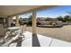 Covered patio overlooking a desert-landscaped backyard with seating and a grill at 11115 E Bellflower Ct, Sun Lakes, AZ 85248