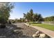 Beautiful view of the community park with walking path, mature trees and lush greenery at 11115 E Bellflower Ct, Sun Lakes, AZ 85248