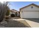 Inviting home exterior with a well-manicured yard, attached garage, and charming walkway at 11115 E Bellflower Ct, Sun Lakes, AZ 85248