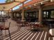 Covered patio seating area with stylish tables and chairs for outdoor dining at 11115 E Bellflower Ct, Sun Lakes, AZ 85248