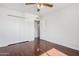 Light-filled bedroom featuring a ceiling fan, hardwood floors, and a large closet at 1117 W Mesquite St, Chandler, AZ 85224