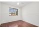 Light-filled bedroom featuring a ceiling fan, hardwood floors, and a large window at 1117 W Mesquite St, Chandler, AZ 85224