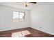 Bright bedroom with hardwood floors and a window with a view of the neighborhood at 1117 W Mesquite St, Chandler, AZ 85224