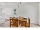 Bright dining area with tile flooring, a wooden table, and a view of the back door at 1117 W Mesquite St, Chandler, AZ 85224