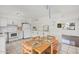 Bright kitchen and dining area with white cabinets, appliances, and tile flooring at 1117 W Mesquite St, Chandler, AZ 85224