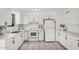 Bright kitchen featuring white cabinets, appliances, tile backsplash, and modern countertops at 1117 W Mesquite St, Chandler, AZ 85224