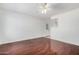 Bright living room featuring glossy hardwood floors, a ceiling fan and a white front door at 1117 W Mesquite St, Chandler, AZ 85224