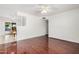 Bright living room with hardwood floors connected to the dining area with a ceiling fan at 1117 W Mesquite St, Chandler, AZ 85224