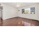 Bright living room with hardwood floors, a ceiling fan and front door access at 1117 W Mesquite St, Chandler, AZ 85224