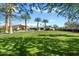 Expansive backyard with a well-maintained lawn and a view of the modern house with its pool area at 11222 N 73Rd St, Scottsdale, AZ 85260