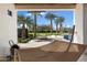 A backyard view showcasing palm trees, lounge furniture, and a luxurious hammock at 11222 N 73Rd St, Scottsdale, AZ 85260