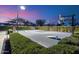 Outdoor basketball court equipped with adjustable hoop, lighting, and landscaping, providing a fun recreational area at 11222 N 73Rd St, Scottsdale, AZ 85260