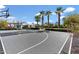 Full-size basketball court with palm trees and lighting, adjacent to a modern home at 11222 N 73Rd St, Scottsdale, AZ 85260