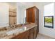 Bathroom features a classic granite countertop, spacious vanity, and ample natural light through a window at 11222 N 73Rd St, Scottsdale, AZ 85260