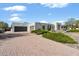 Contemporary home featuring a desert landscape, brick driveway, and an attached two-car garage at 11222 N 73Rd St, Scottsdale, AZ 85260