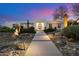 Modern home exterior features desert landscaping with cacti, uplighting, and a sleek walkway at 11222 N 73Rd St, Scottsdale, AZ 85260