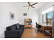 Bright home office space featuring hardwood floors, modern shelving, and a comfortable sofa at 11222 N 73Rd St, Scottsdale, AZ 85260