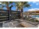 Modern outdoor shower with wood platform, black privacy screen, and palm trees, steps from pool at 11222 N 73Rd St, Scottsdale, AZ 85260