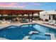 Inviting pool area with an outdoor kitchen, lounge seating, and a serene spa for relaxation and entertainment at 11222 N 73Rd St, Scottsdale, AZ 85260