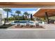 Stunning backyard pool area with lounge chairs, umbrellas, and outdoor entertainment space with a fireplace at 11222 N 73Rd St, Scottsdale, AZ 85260