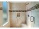 Stylish shower with a glass door and bench, featuring elegant tile and a convenient shower niche at 11222 N 73Rd St, Scottsdale, AZ 85260