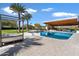 A backyard pool and patio seating area with a covered outdoor living space at 11222 N 73Rd St, Scottsdale, AZ 85260