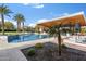 A sparkling swimming pool surrounded by palm trees and an outdoor kitchen at 11222 N 73Rd St, Scottsdale, AZ 85260