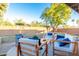 Cozy backyard with a fire pit, comfortable seating, lush greenery, and string lights at 15035 N 54Th St, Scottsdale, AZ 85254