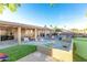 Spacious backyard featuring a covered patio, outdoor seating, putting green, and fenced pool for entertainment at 15035 N 54Th St, Scottsdale, AZ 85254