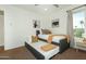 Cozy bedroom with neutral decor, a trundle bed, and a window providing natural light at 15035 N 54Th St, Scottsdale, AZ 85254