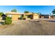 Charming single-story home with a well-maintained desert landscape, a two car garage, and clear blue sky at 15035 N 54Th St, Scottsdale, AZ 85254