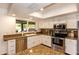 Bright kitchen featuring white cabinets, stainless steel appliances, granite countertops, and ample natural light at 15035 N 54Th St, Scottsdale, AZ 85254