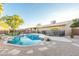 Beautiful backyard pool featuring a rock waterfall and desert landscaping at 15035 N 54Th St, Scottsdale, AZ 85254