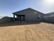 Exterior view of the backyard with an outdoor patio and block wall at 15744 W Beryl Ave, Waddell, AZ 85355