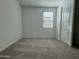 Comfortable bedroom featuring carpet, a window for natural light, and a closet at 15744 W Beryl Ave, Waddell, AZ 85355