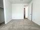 Inviting carpeted bedroom with a door, and light-colored walls at 15744 W Beryl Ave, Waddell, AZ 85355