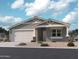 Charming single-story home showcasing desert landscaping, a two car garage, and stylish architectural details at 15744 W Beryl Ave, Waddell, AZ 85355