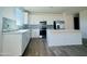 A well-lit kitchen with stainless steel appliances, white cabinetry, and an island perfect for entertaining at 15744 W Beryl Ave, Waddell, AZ 85355