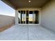 Covered patio with concrete slab and sliding glass door at 15744 W Beryl Ave, Waddell, AZ 85355