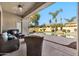 Inviting covered patio and outdoor living area with a pool and mature landscaping create a resort-style oasis at 1738 W Yosemite Pl, Chandler, AZ 85248