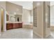 Bathroom featuring double vanity, soaking tub, and a decorative glass block window at 1738 W Yosemite Pl, Chandler, AZ 85248