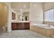 Bathroom featuring double vanity with soaking tub, toilet, and window at 1738 W Yosemite Pl, Chandler, AZ 85248