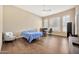 Bedroom with hardwood floors, modern ceiling fan, and an abundance of natural light at 1738 W Yosemite Pl, Chandler, AZ 85248