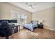 Bright bedroom featuring wood floors, shutters, and a ceiling fan, perfect for relaxation and productivity at 1738 W Yosemite Pl, Chandler, AZ 85248